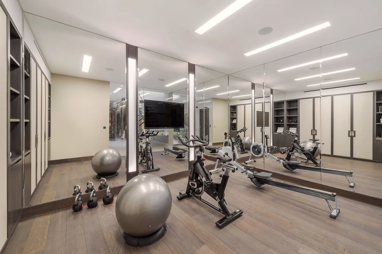 Basement Extension A modern home gym featuring exercise equipment and large mirrors.