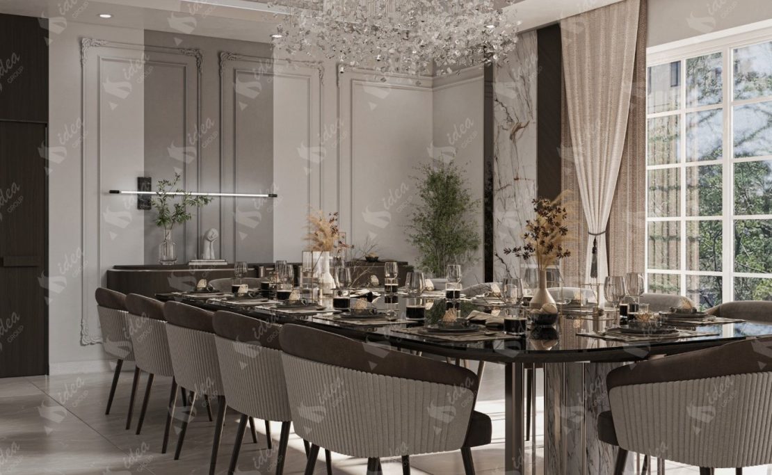 Dining room Elegant dining room with a long table set for dinner, featuring modern decor and a chandelier.